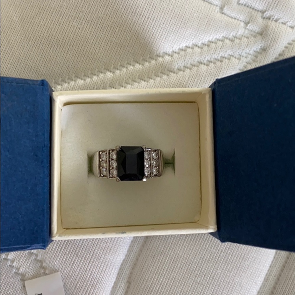 Rhodium ring with sapphire colored stone and CZs.